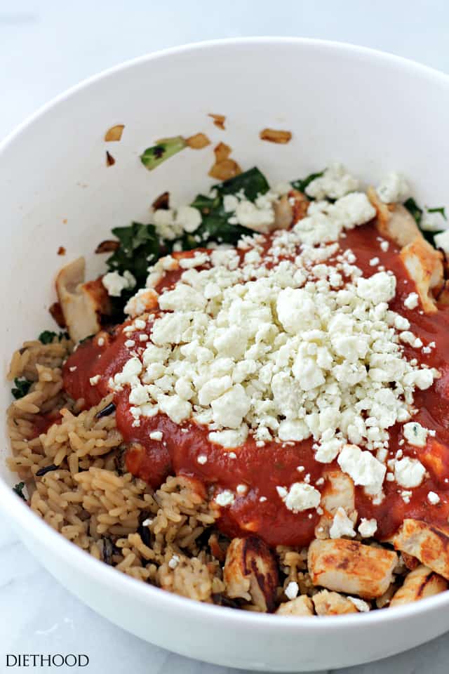 Adding the tomato sauce and blue cheese to the chicken mixture.