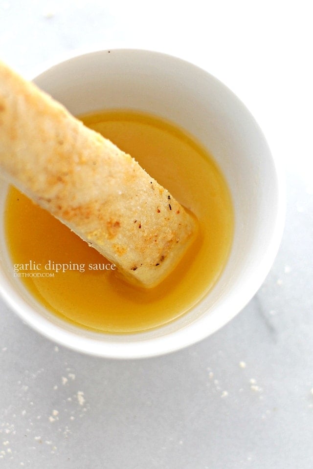 dipping Parmesan Breadstick in Garlic Dipping Sauce 