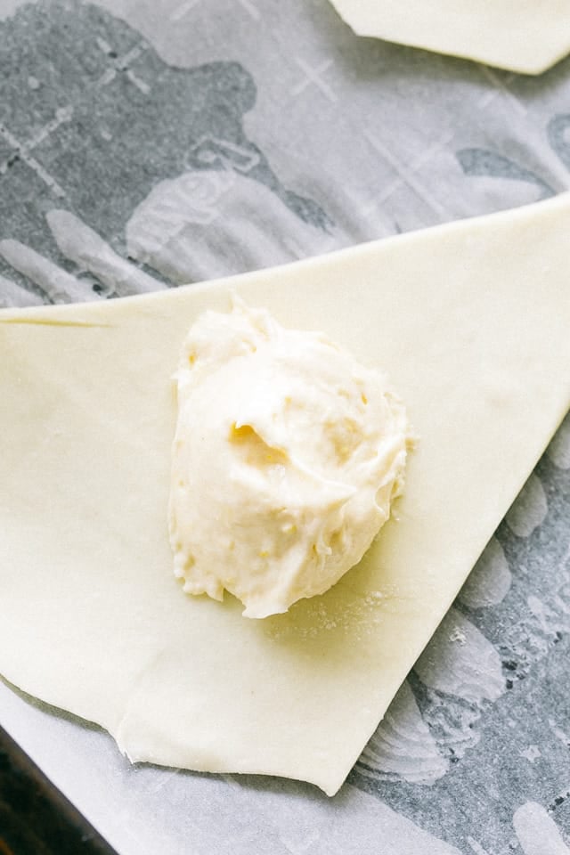 A tablespoon of lemon cheesecake filling arranged in the center of crescent roll dough.