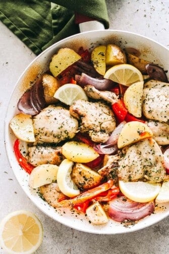 Chicken and veggies in the skillet with lemon-garlic marinade.