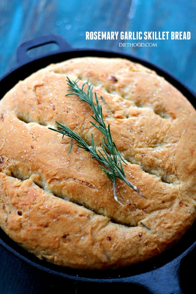 Photo of a No-Knead Skillet Bread topped with sprigs of fresh rosemary.