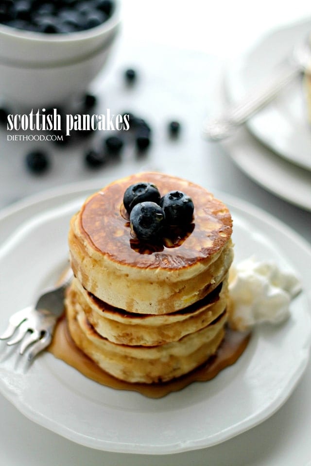Scottish Pancakes served on a plate and topped with blueberries. 