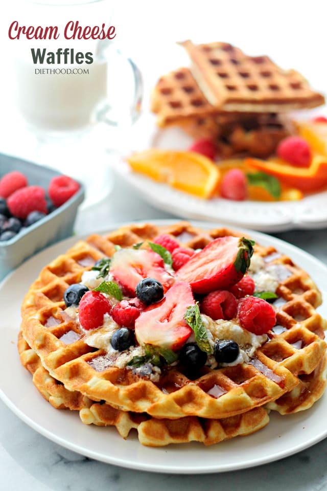 plated Cream Cheese Waffles topped with berries and syrup. 