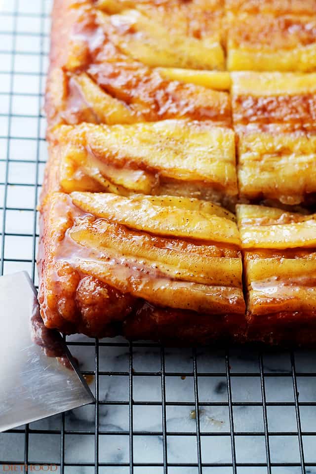 Closeup image of banana upside down cake on a cooling wrack.