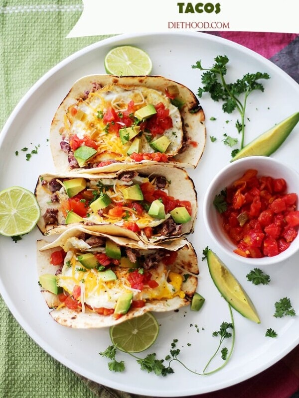 Huevos Rancheros Tacos | www.diethood.com | Soft tortillas stuffed with homemade refried beans, eggs, green chilies, tomatoes, cheese and diced avocados. Simple, but incredibly delicious!