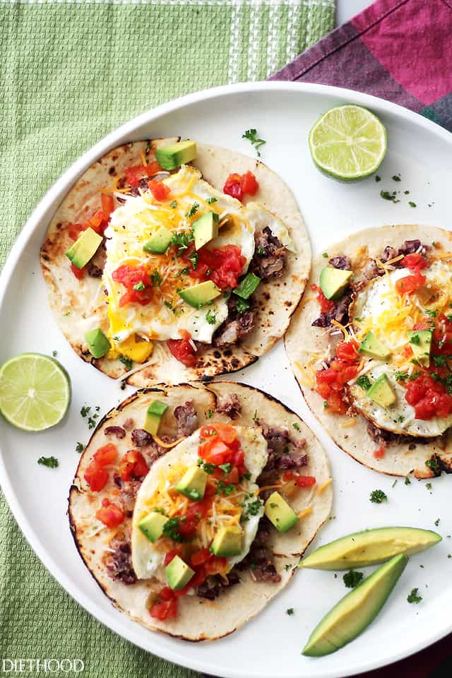 Huevos Rancheros Tacos | www.diethood.com | Soft tortillas stuffed with homemade refried beans, eggs, green chilies, tomatoes, cheese and diced avocados. Simple, but incredibly delicious!