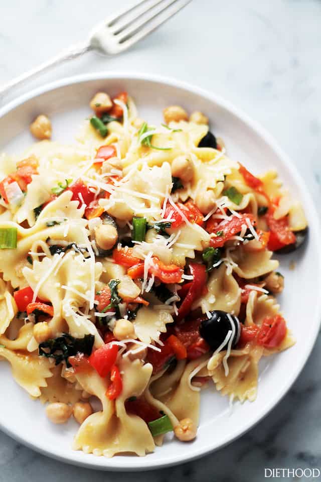 Italian pasta and stir-fried vegetables served on a dinner plate.