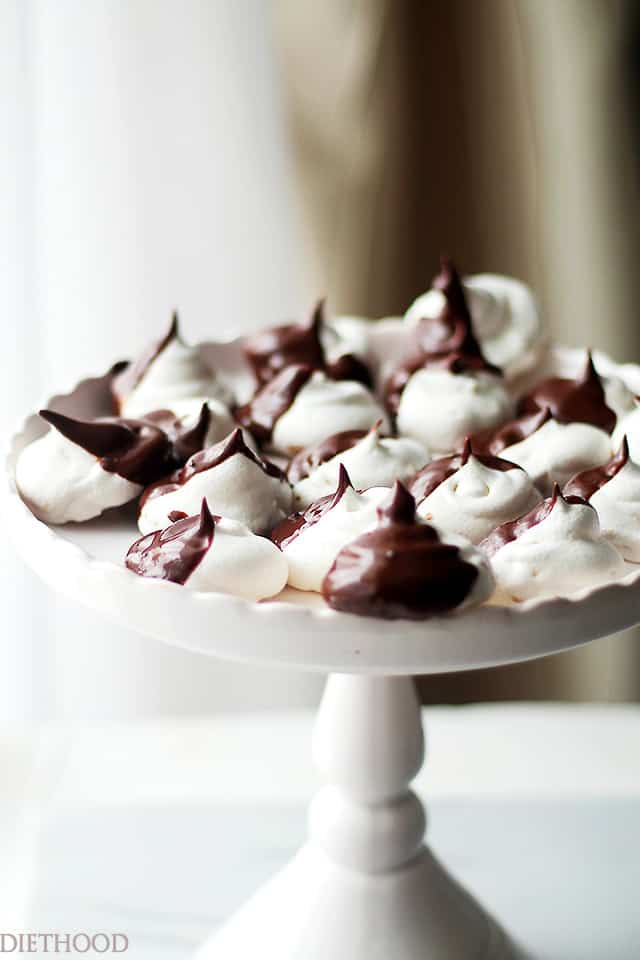 Black and white meringue cookies on a cake stand.