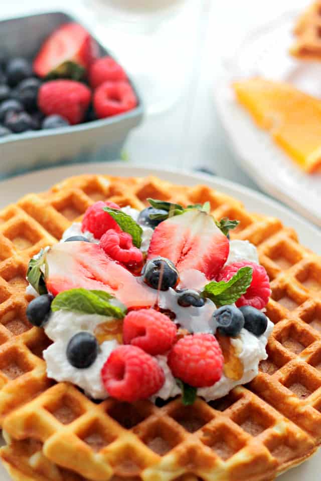 Close-up photo of maple syrup drizzling over cream cheese waffles.