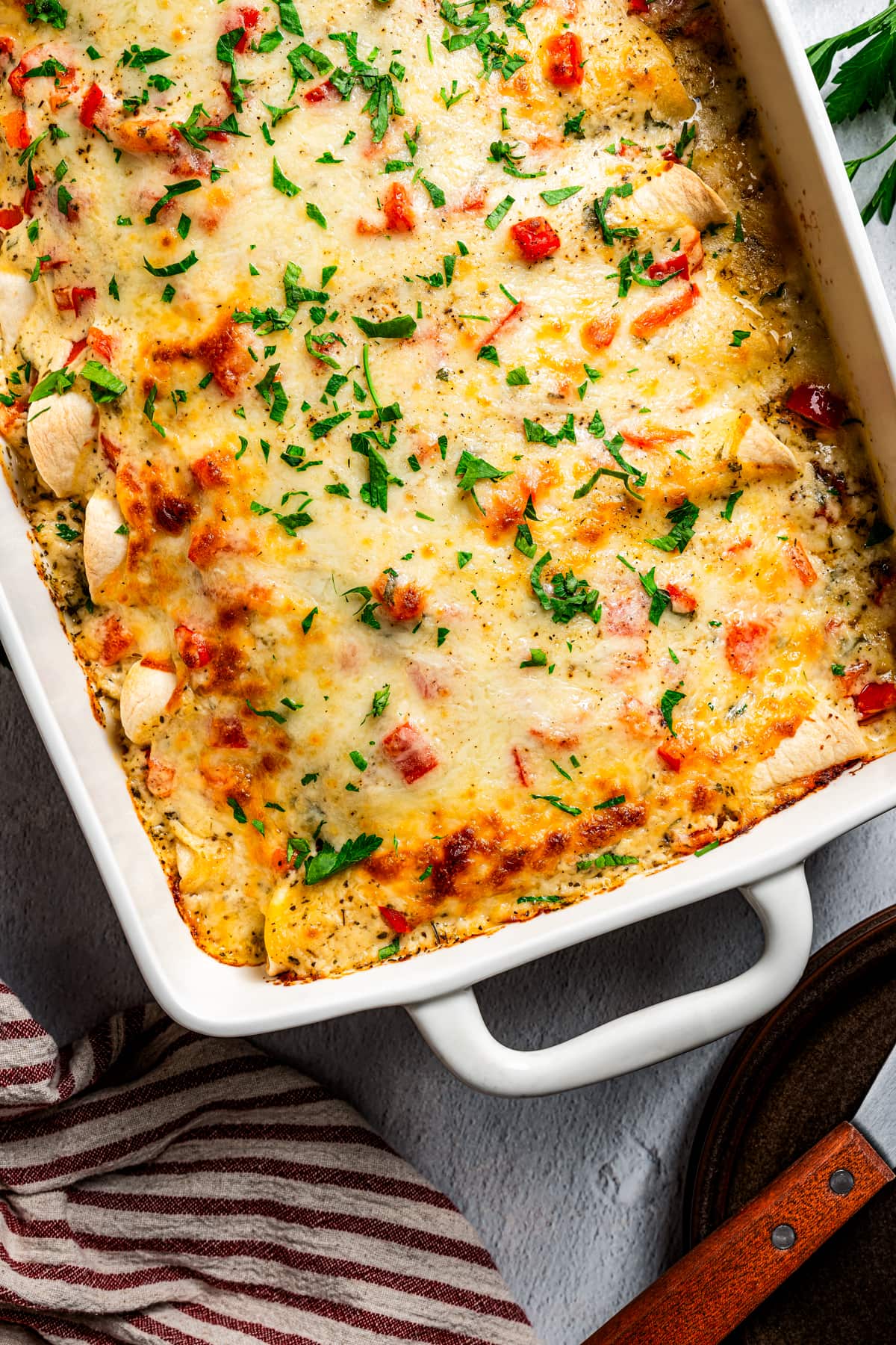 Overhead image of chicken enchilada casserole in a baking dish.