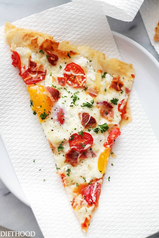 Bacon and Eggs Phyllo Breakfast Pizza | www.diethood.com | Crispy bacon, soft eggs and cherry tomatoes settled on top of phyllo sheets smothered with a seasoned feta cheese spread.