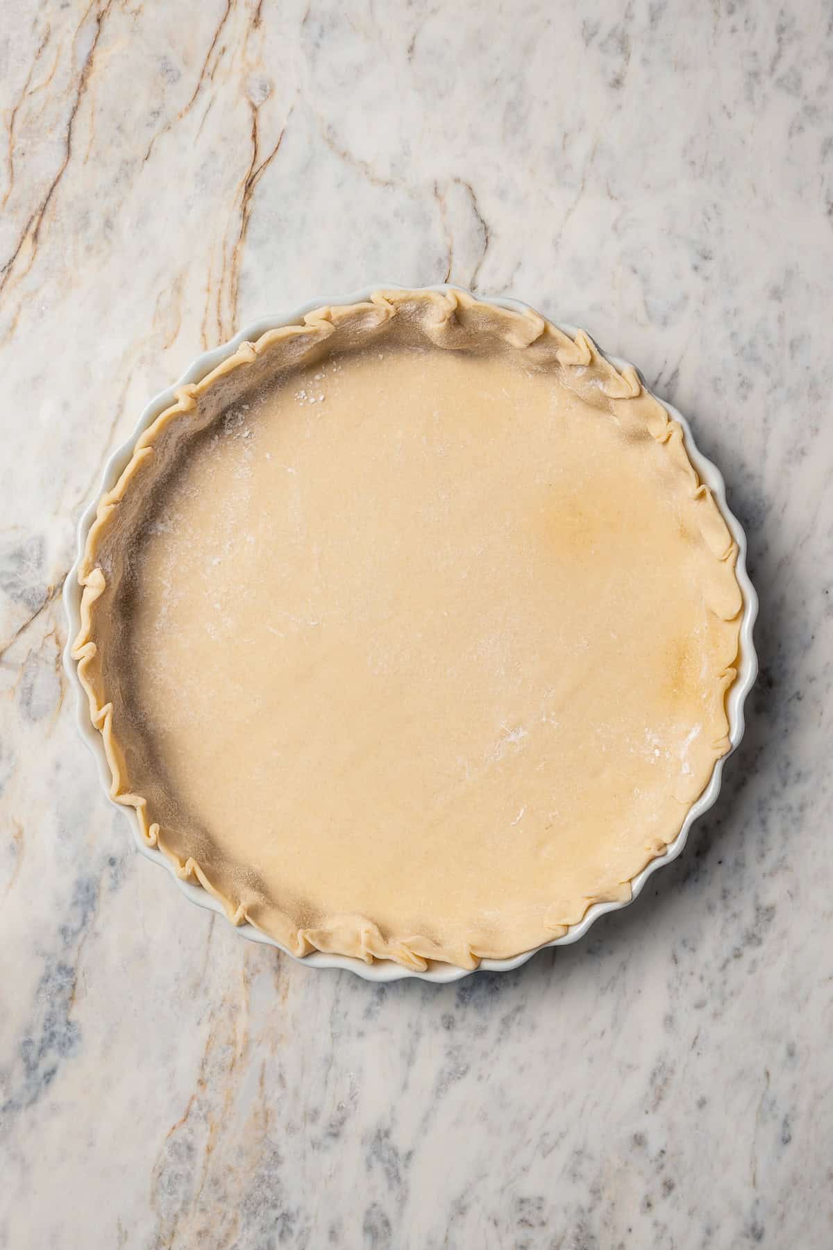 This peach blueberry pie is a fruit-filled custard pie bursting with juicy fresh peaches and blueberries, topped with a nutty pecan streusel. Pie crust pressed into a tart plate.
