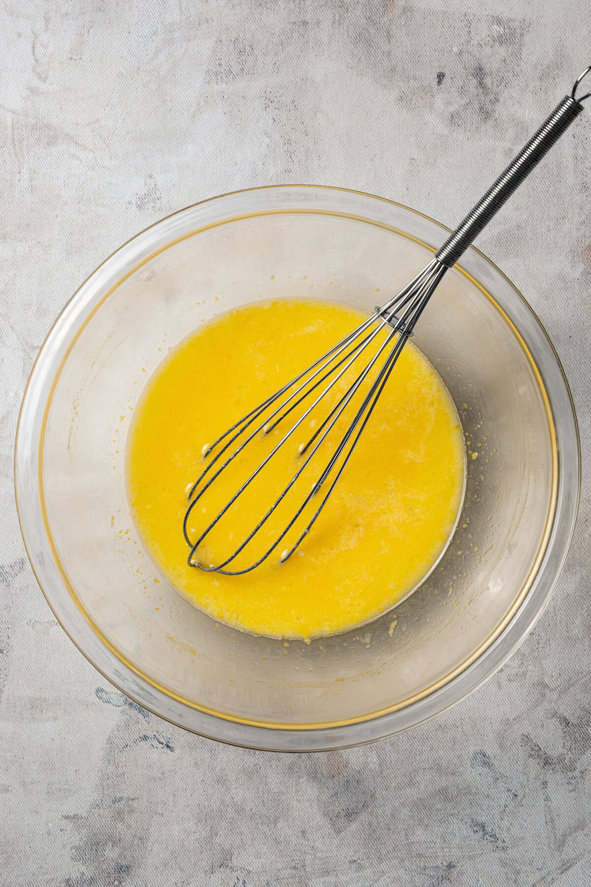 Lemon bar filling whisked in a bowl.
