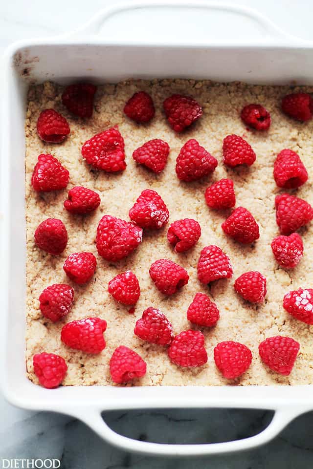 Raspberry Lemon Bars | www.diethood.com | Bursting with flavor and texture, these Lemon Bars are not only delicious, but at 150 calories per serving, they're also much lighter than your classic Lemon Bars.