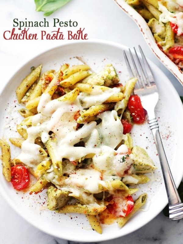 Spinach Pesto Chicken Pasta Bake - A delicious and easy recipe made with chicken, whole wheat pasta and tomatoes tossed in a creamy spinach pesto sauce and topped with cheese. This pasta is a winner every time AND it freezes great, too! Get the recipe on diethood.com