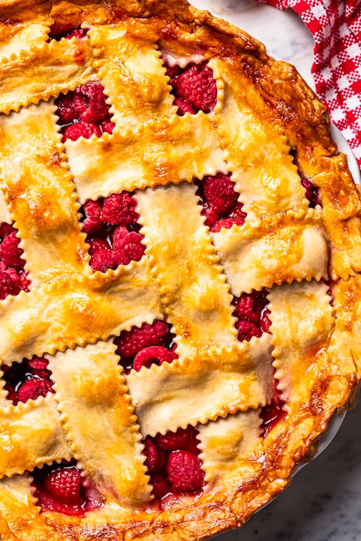 This easy mixed berry pie recipe combines three types of juicy berries with tender apples inside a light and flaky homemade pie crust. Berry pie with lattice top.