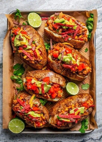 Loaded baked potatoes arranged on a serving tray.