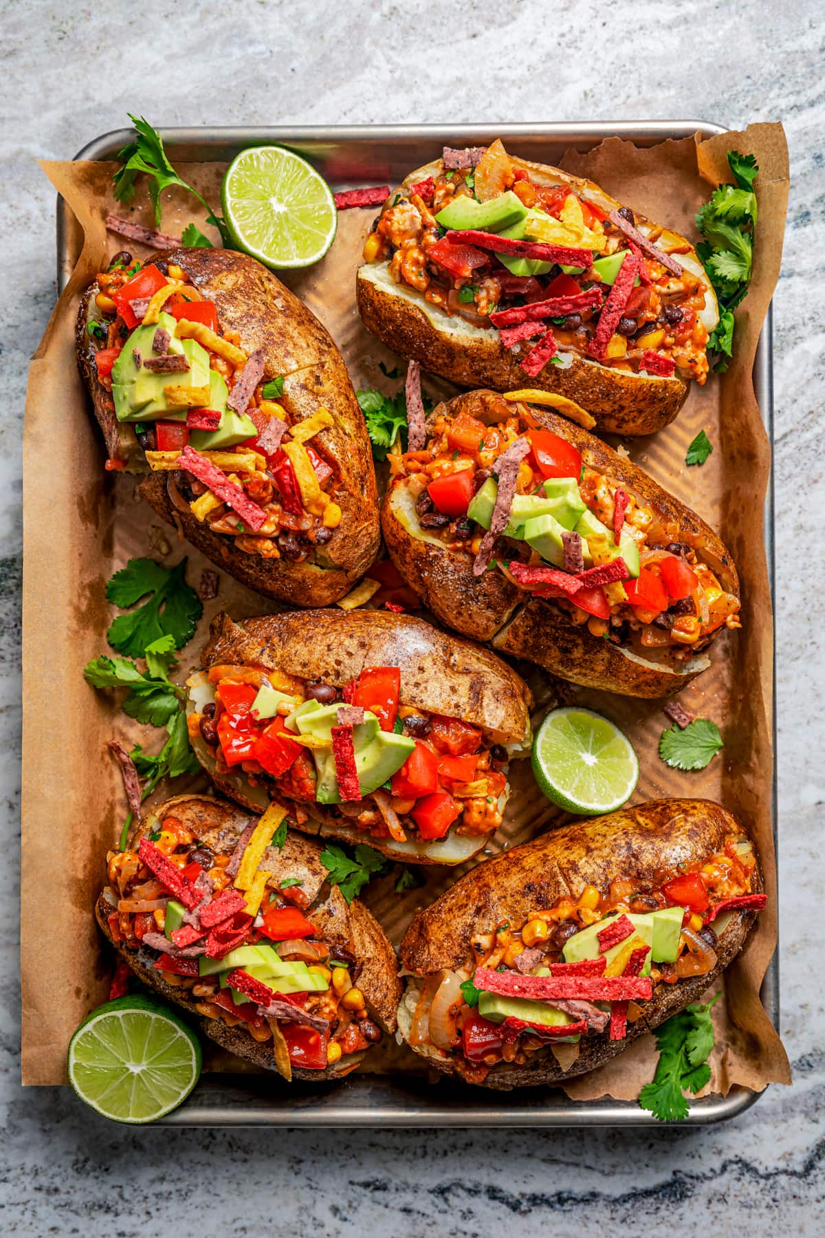 Loaded baked potatoes arranged on a serving tray.