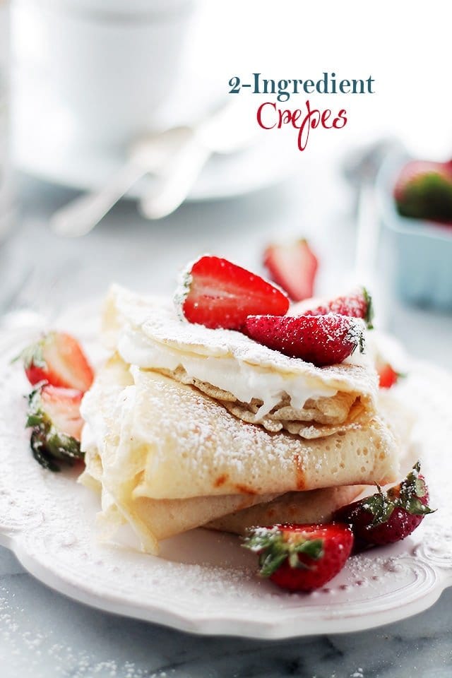 crepes filled with whipping cream and topped with sliced strawberries