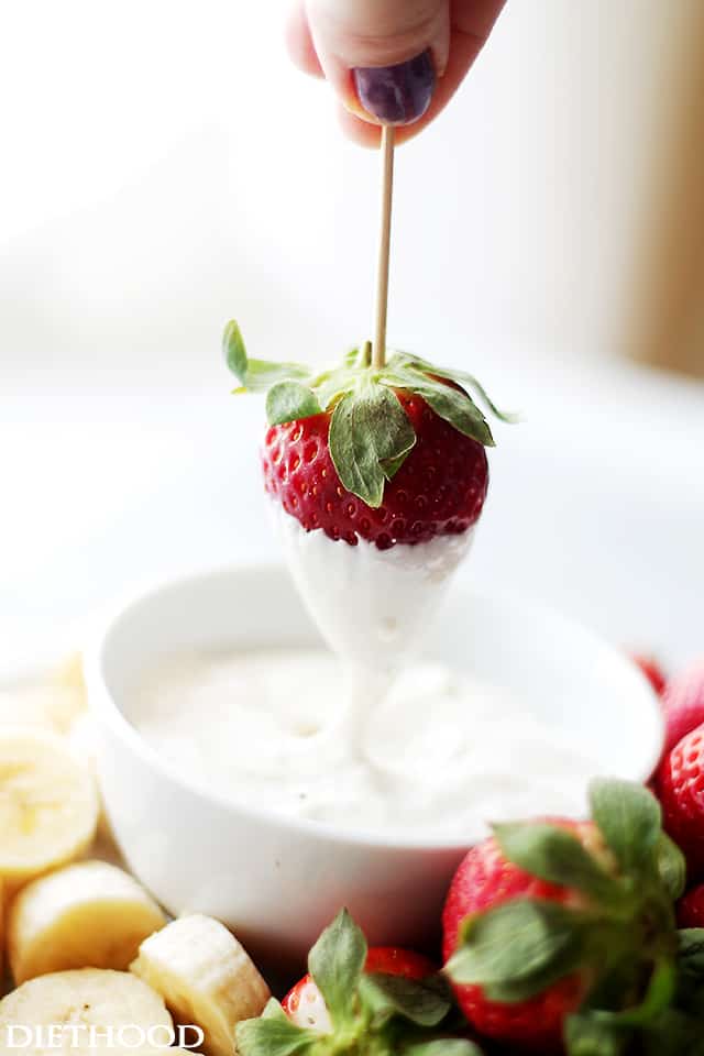 Dipping fruits in Cream Cheese Fruit Dip.