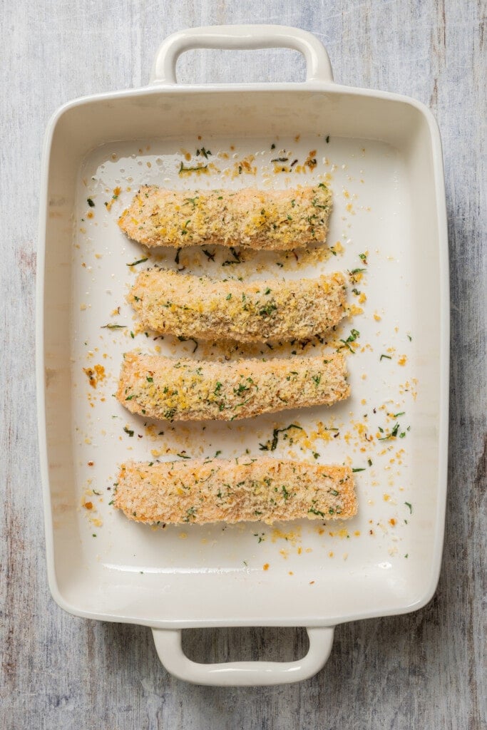 Baked panko crusted salmon filets in a baking dish.