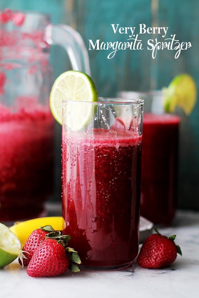 Very Berry Margarita Spritzer in a tall glass with berries nearby