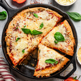 Overhead image of a deep dish pizza in a skillet.