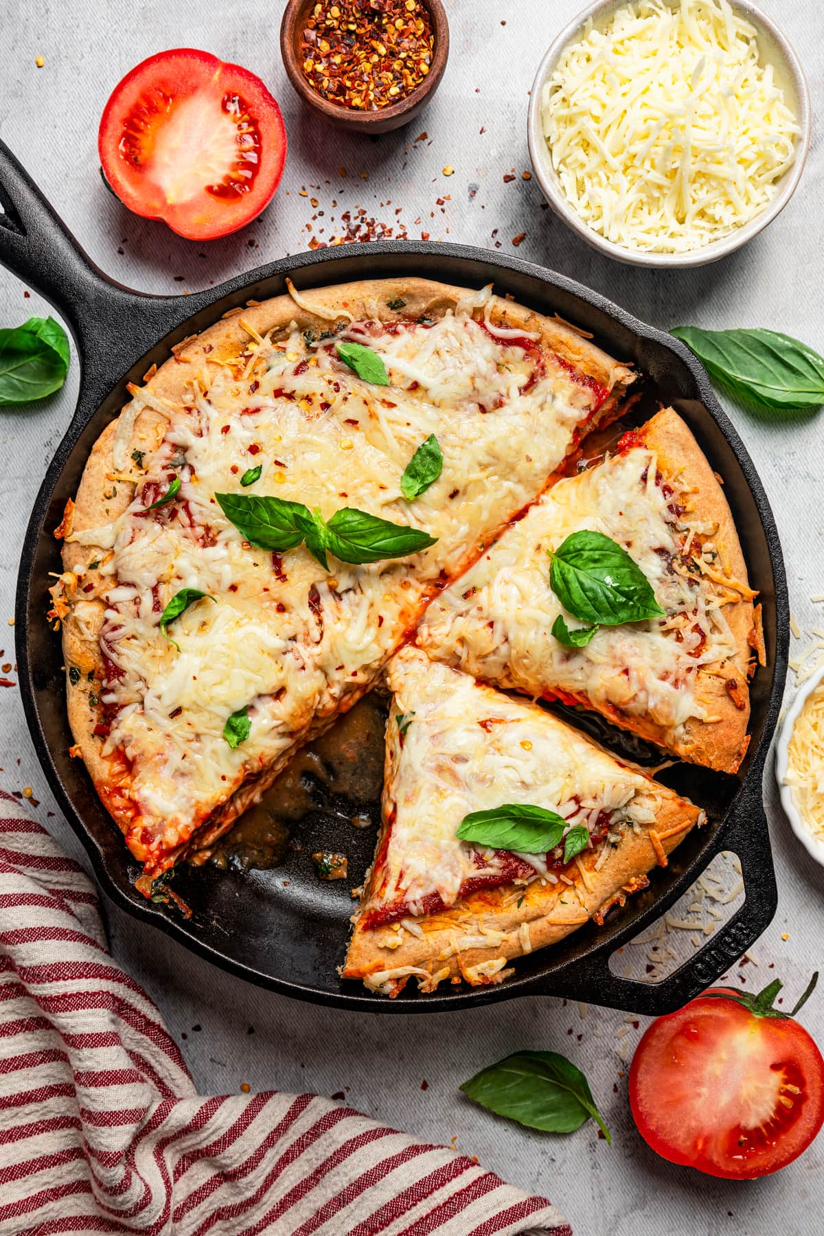 Overhead image of a deep dish pizza in a skillet.