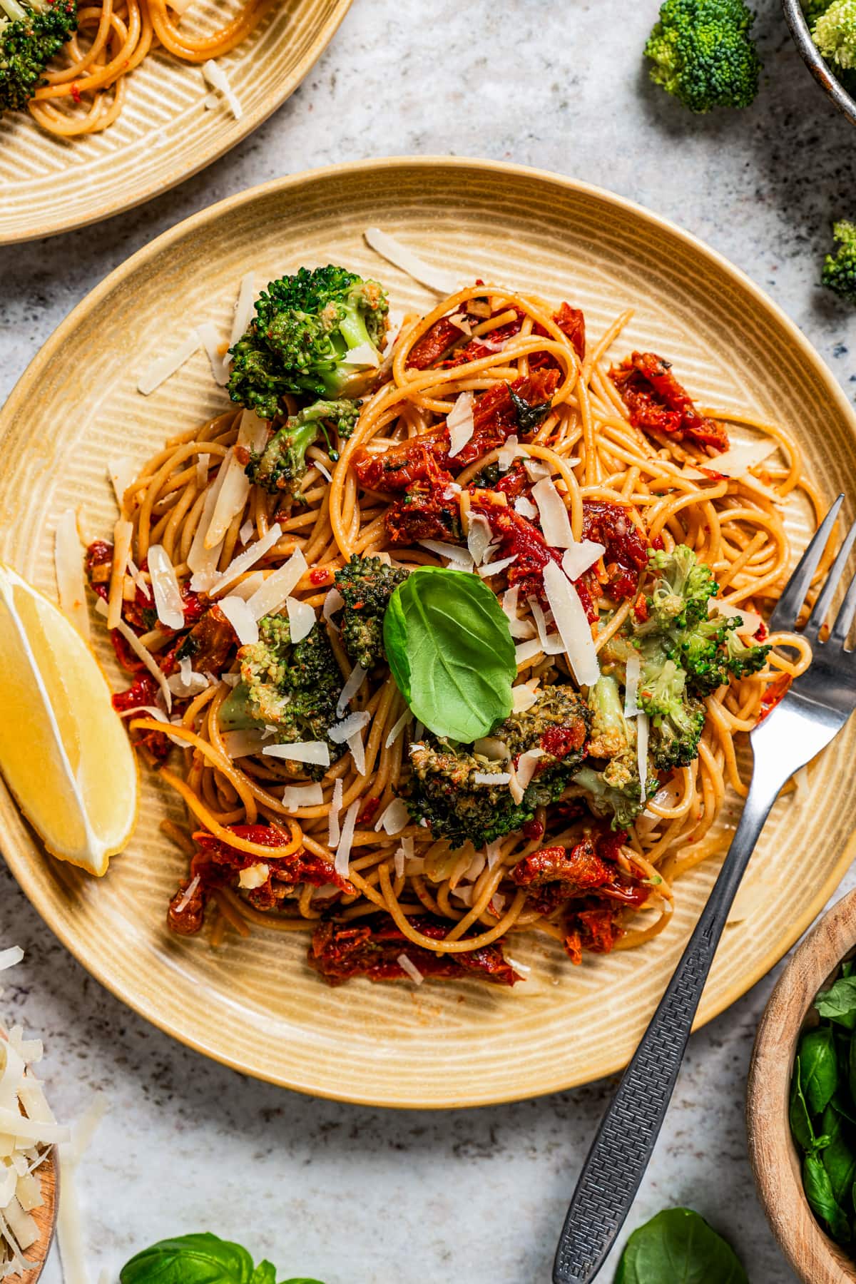 Sun-dried tomato pasta with broccoli served on a plate.