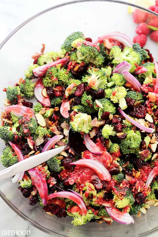 Crunchy Broccoli Salad with Raspberry Vinaigrette - Simple, healthy, easy to make Broccoli Salad with nuts, fruits and bacon! The delicious homemade Raspberry Vinaigrette brings it all together. Get the recipe on diethood.com