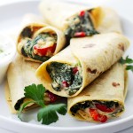 A pile of Creamy Spinach and Feta Cheese Tortilla Wraps served on a plate.