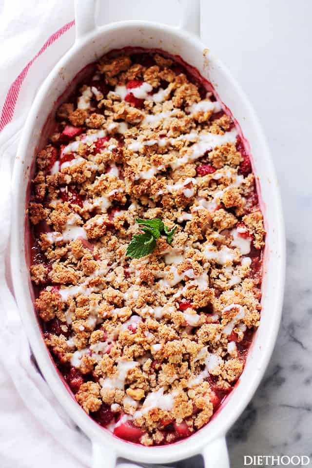 Overhead view of strawberry crumble in an oval baking dish.