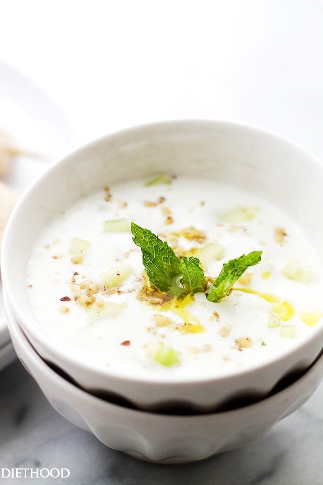 Cucumber-Garlic Yogurt Sauce {Taratur} in a bowl with fresh herbs