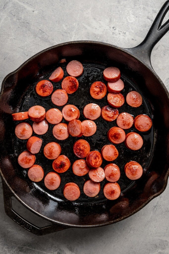 Browning the sausage in the pan. 