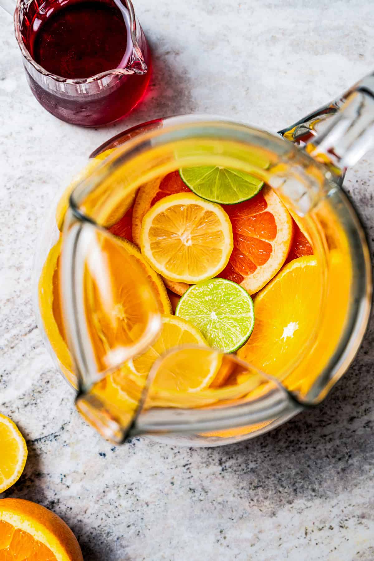 Overhead view of a pitcher filled with sliced citrus.