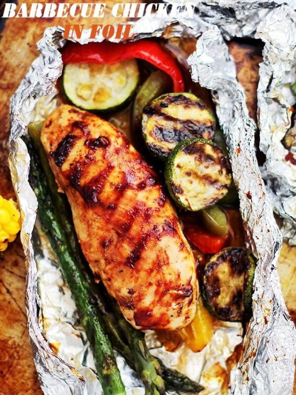 Grilled Barbecue Chicken and Vegetables in Foil - Tender, flavorful chicken covered in sweet barbecue sauce and cooked on the grill inside foil packs with zucchini, bell peppers and asparagus.