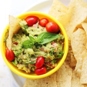 Basil Guacamole - A delicious twist on the classic guacamole made with fresh basil, tomatoes, onions and lime.