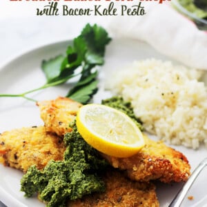 Breaded Baked Pork Chops with Bacon-Kale Pesto - Tender and delicious Pork Chops coated in oyster crackers and cheese served with a side of a truly mouthwatering homemade Bacon-Kale Pesto.