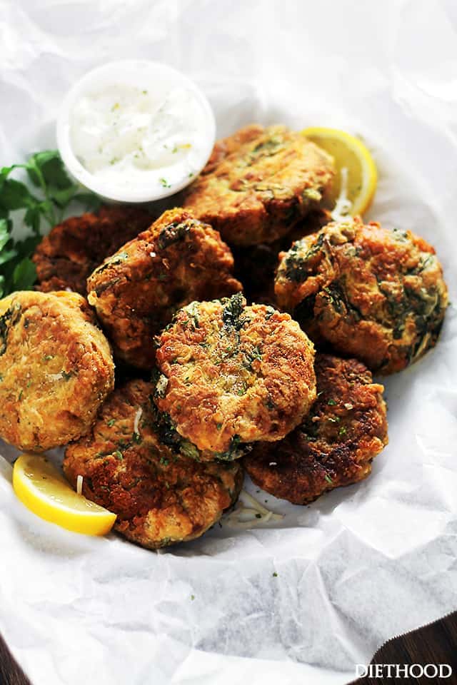 Lentil fritters served in a lined basket with a side of dipping sauce.