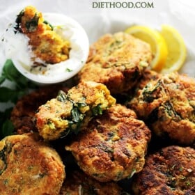 Spinach Lentil Fritters - Deliciously crispy fritters made with lentils and spinach, and served with a side of lemon-sour cream sauce.