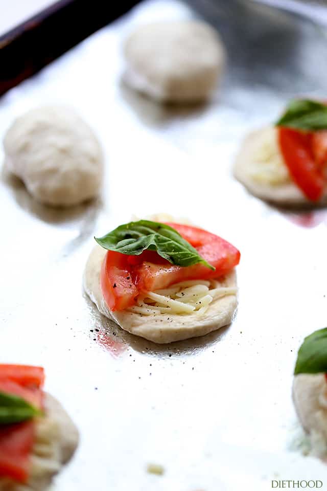 Filling biscuit dough with mozzarella, tomato, and basil.