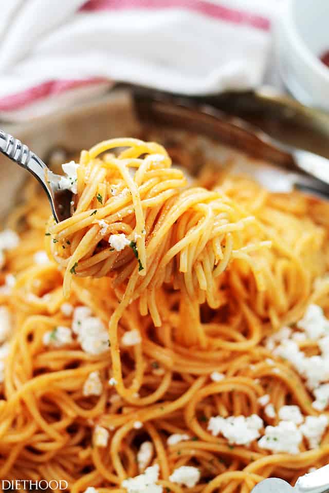 A fork holding up ketchup spaghetti.