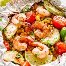 Foil packs with shrimp, corn, and zucchini.