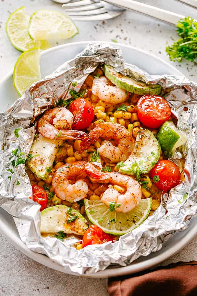 Grilled shrimp in foils on a plate.