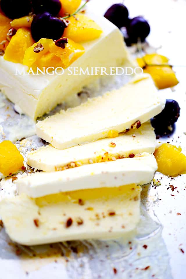 Mango semifreddo topped with fresh cherries, canned mangoes and toasted pecans
