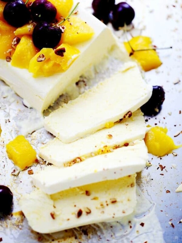 Four slices of mango semifreddo with the remaining semifreddo beside them