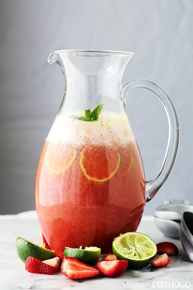 Adding sparkling water to strawberry limeade base.