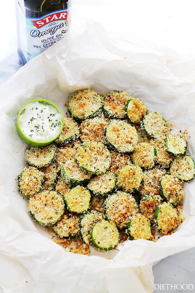 Baked Garlic Parmesan Zucchini Chips served in a paper-lined bowl.