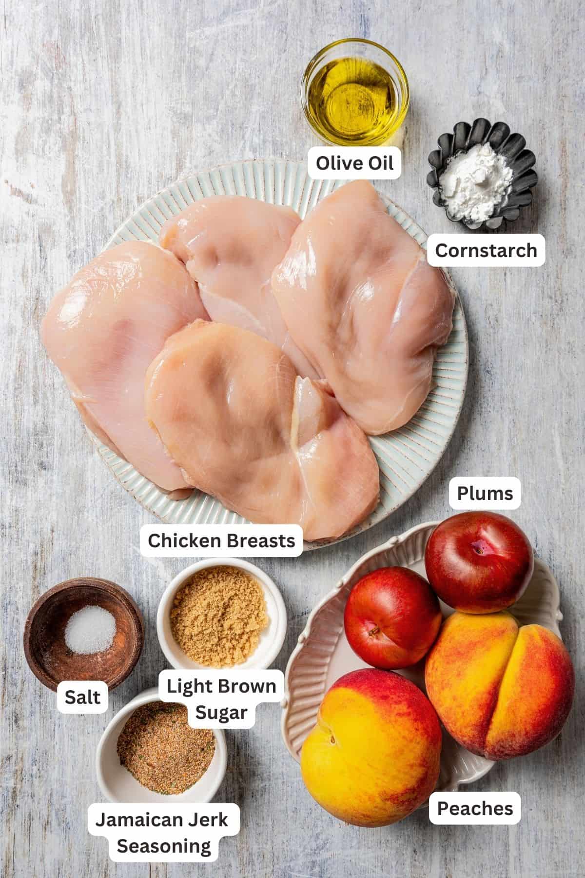 Ingredients for Jamaican jerk chicken and stone fruit sauce with text labels overlaying each ingredient.