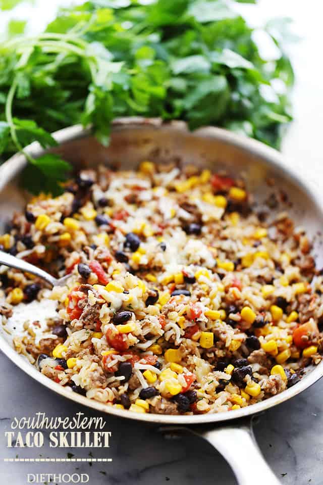 Taco skillet in a skillet near a bunch of fresh cilantro.